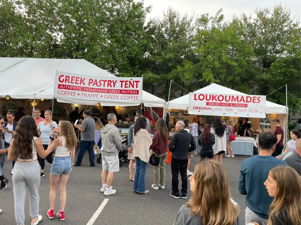 Visitors dancing outside the Pastry and Loukoumades tents